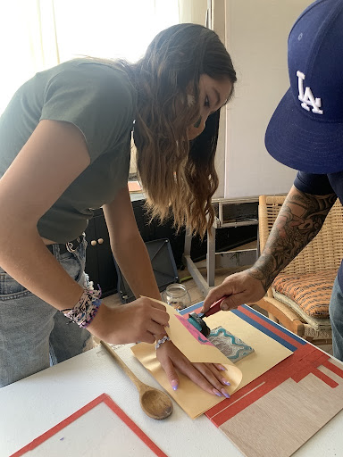 Two TISA students working on print together